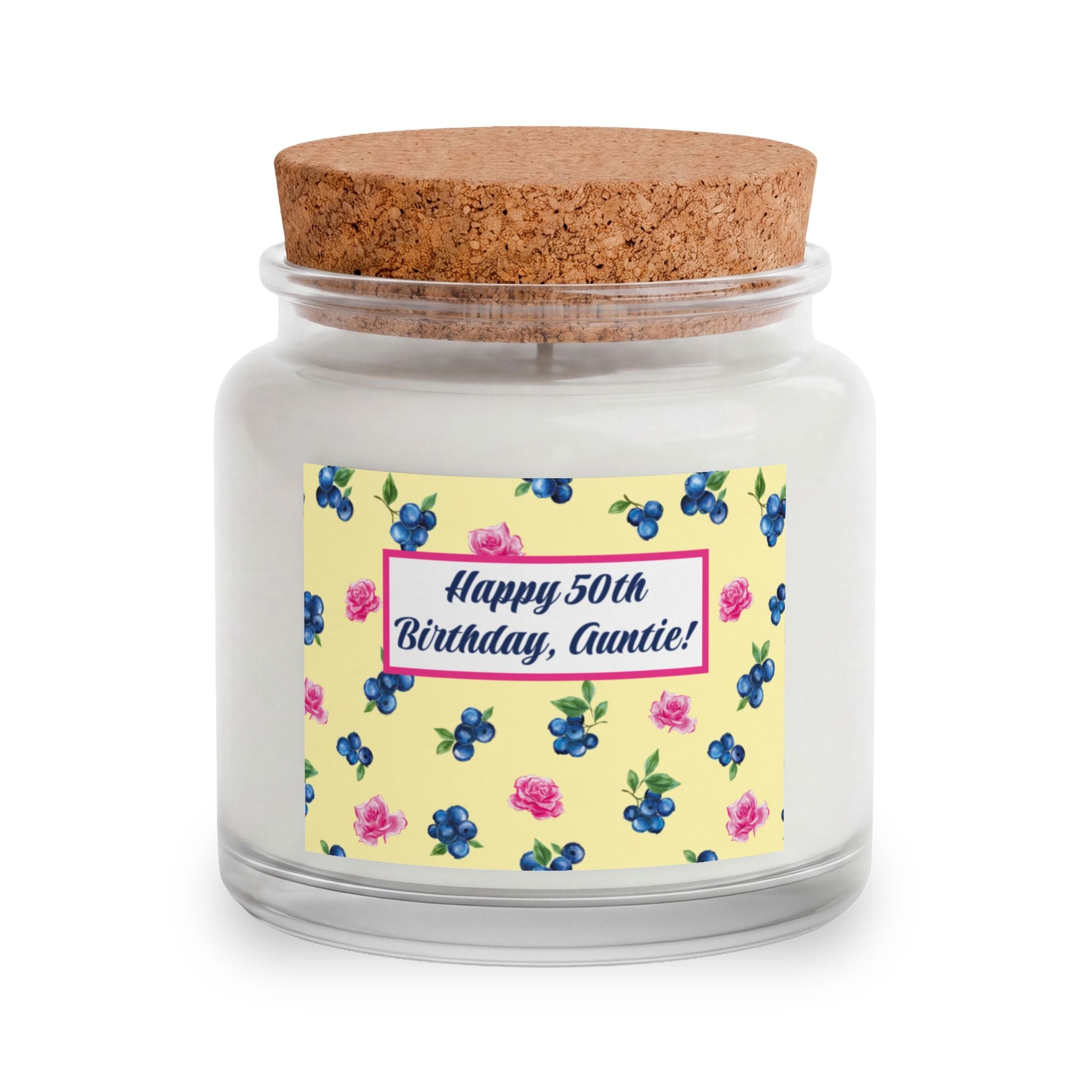 Image of A personalized jar candle with a white wax fill, a natural cork lid, and a yellow label decorated with blueberries and pink roses. The label features a pink border and the text 'Happy 50th Birthday, Auntie!'